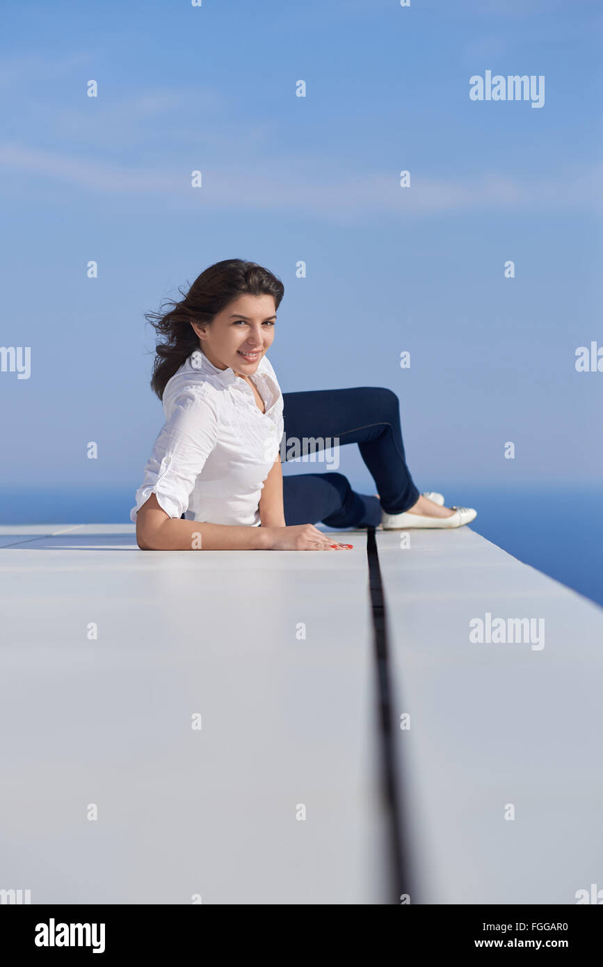 relaxed woman in front of luxury modern home Stock Photo - Alamy