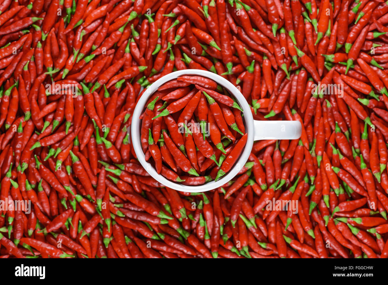 Mug full of red peppers. Depth of field with focus on top of the mug. Stock Photo