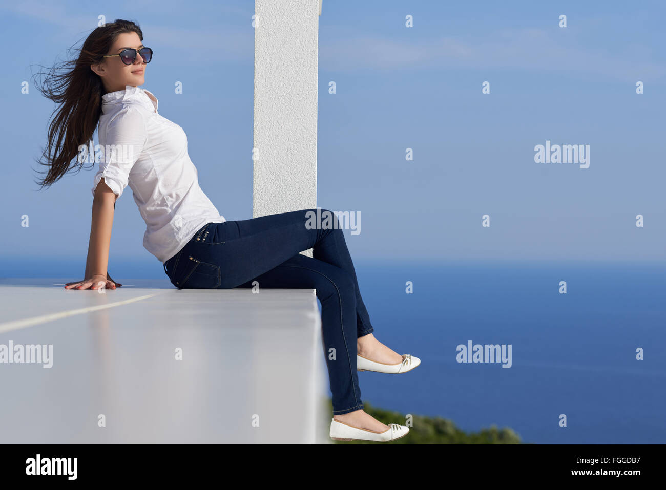 relaxed woman in front of luxury modern home Stock Photo - Alamy