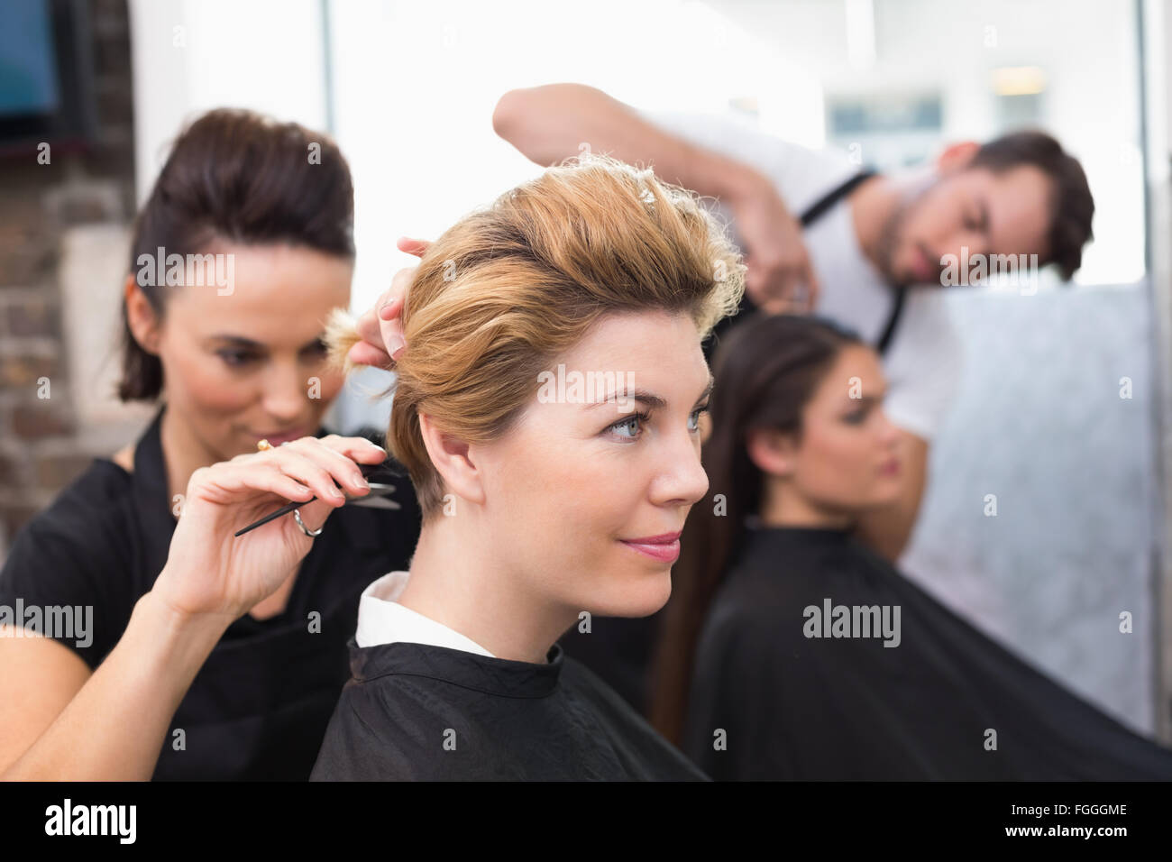 Hairdressers working on their clients Stock Photo Alamy