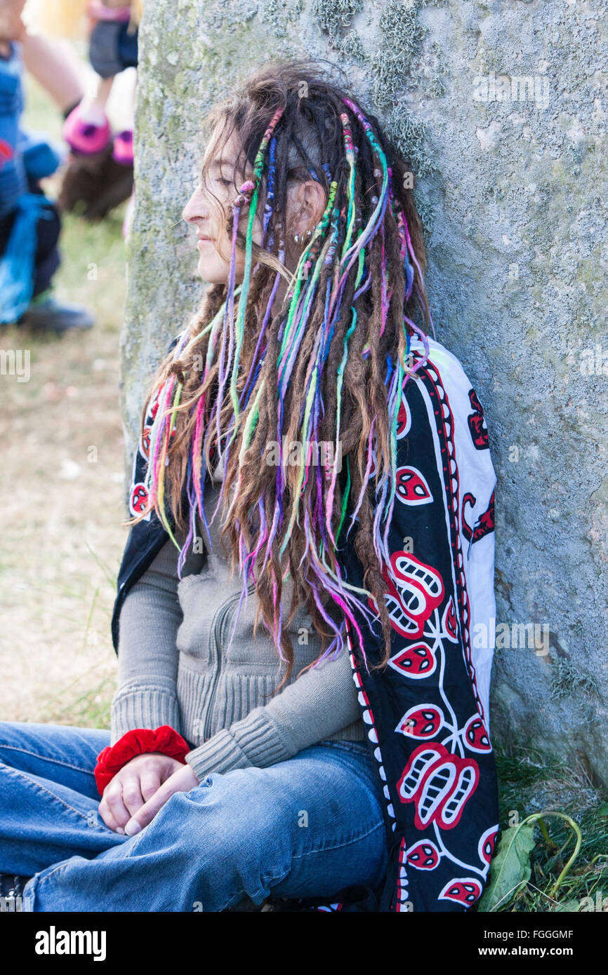 woman,Hippy,hippie,meditate,healing,meditation,meditating,at,touching,stones,stone,at,Stonehenge,Summer Solstice sunrise June,Wiltshire,England, Stock Photo