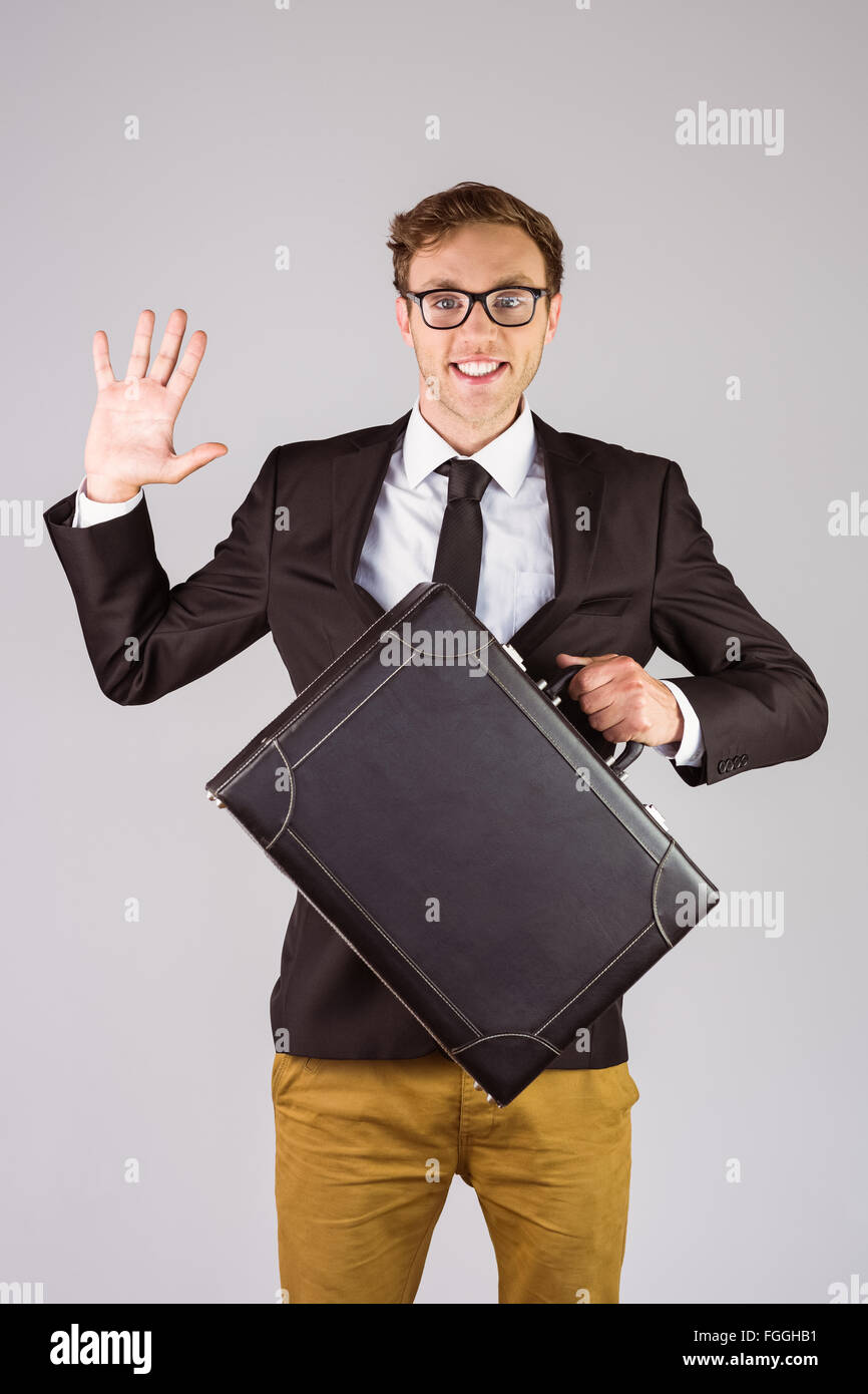 Young geeky businessman holding briefcase Stock Photo - Alamy