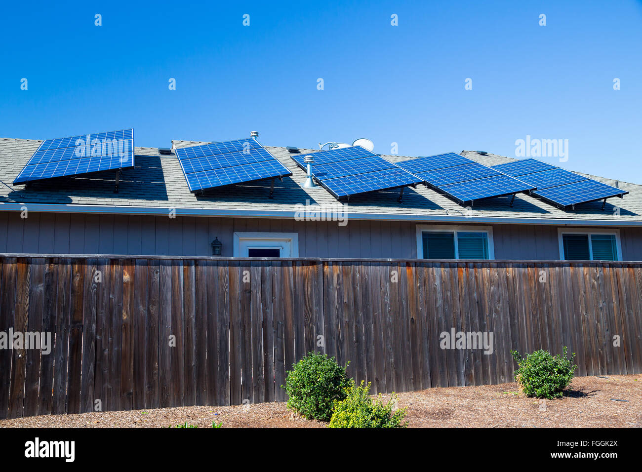 Sustainable energy from the sun goes into these solar panels on top of a house in Oregon. Stock Photo