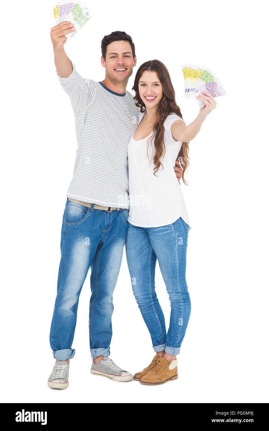 Happy couple holding money Stock Photo - Alamy