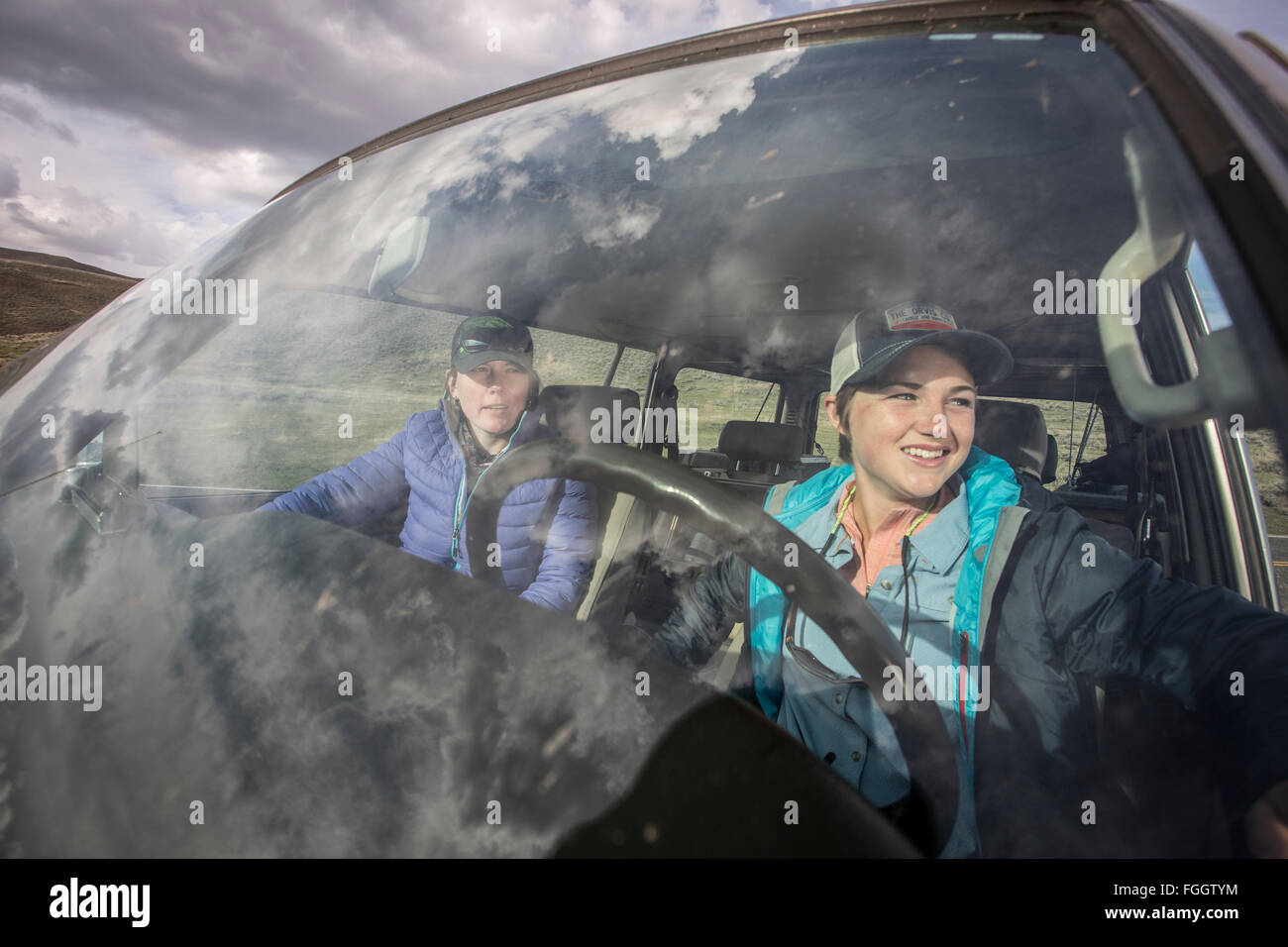 Two girls in outdoor clothing in 1990 Land Cruiser. Stock Photo