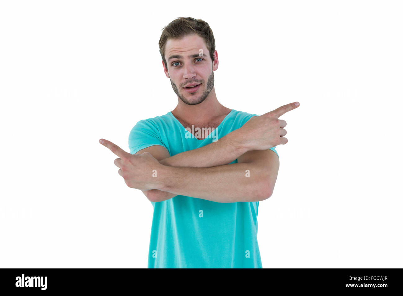 Hipster pointing sideways with arms crossed Stock Photo