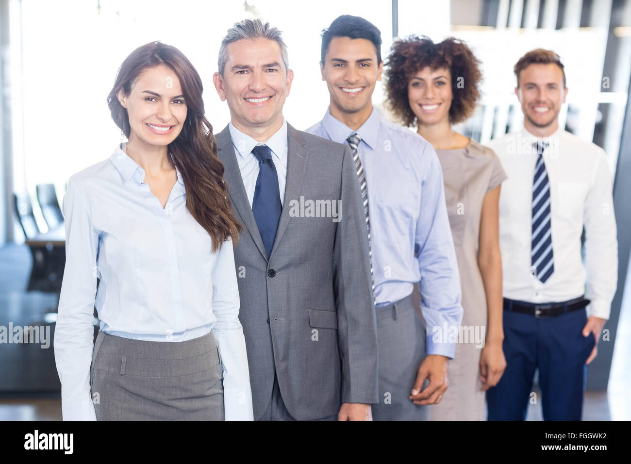 Business team standing in a row in office Stock Photo - Alamy