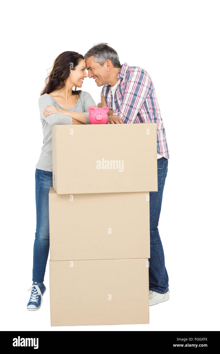 Couple with boxes and piggy bank Stock Photo - Alamy