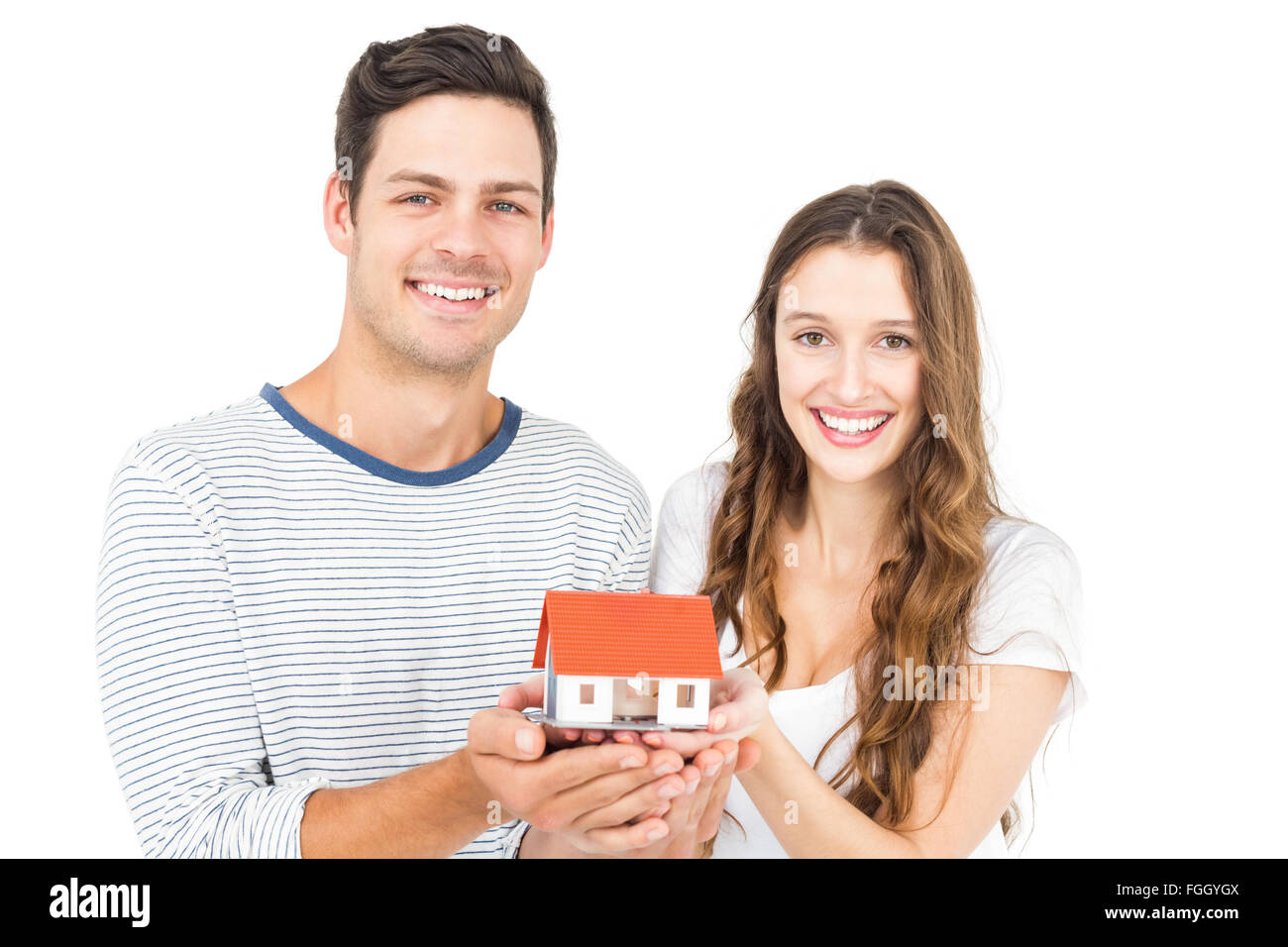 Happy couple holding miniature house Stock Photo - Alamy