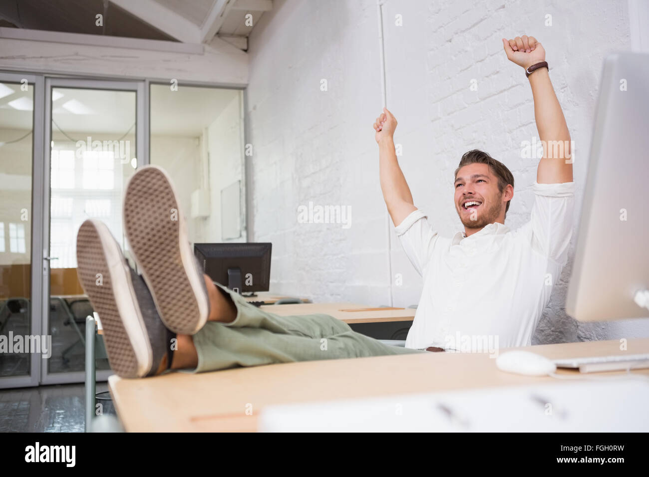 Cheerful businessman cheering in office Stock Photo - Alamy