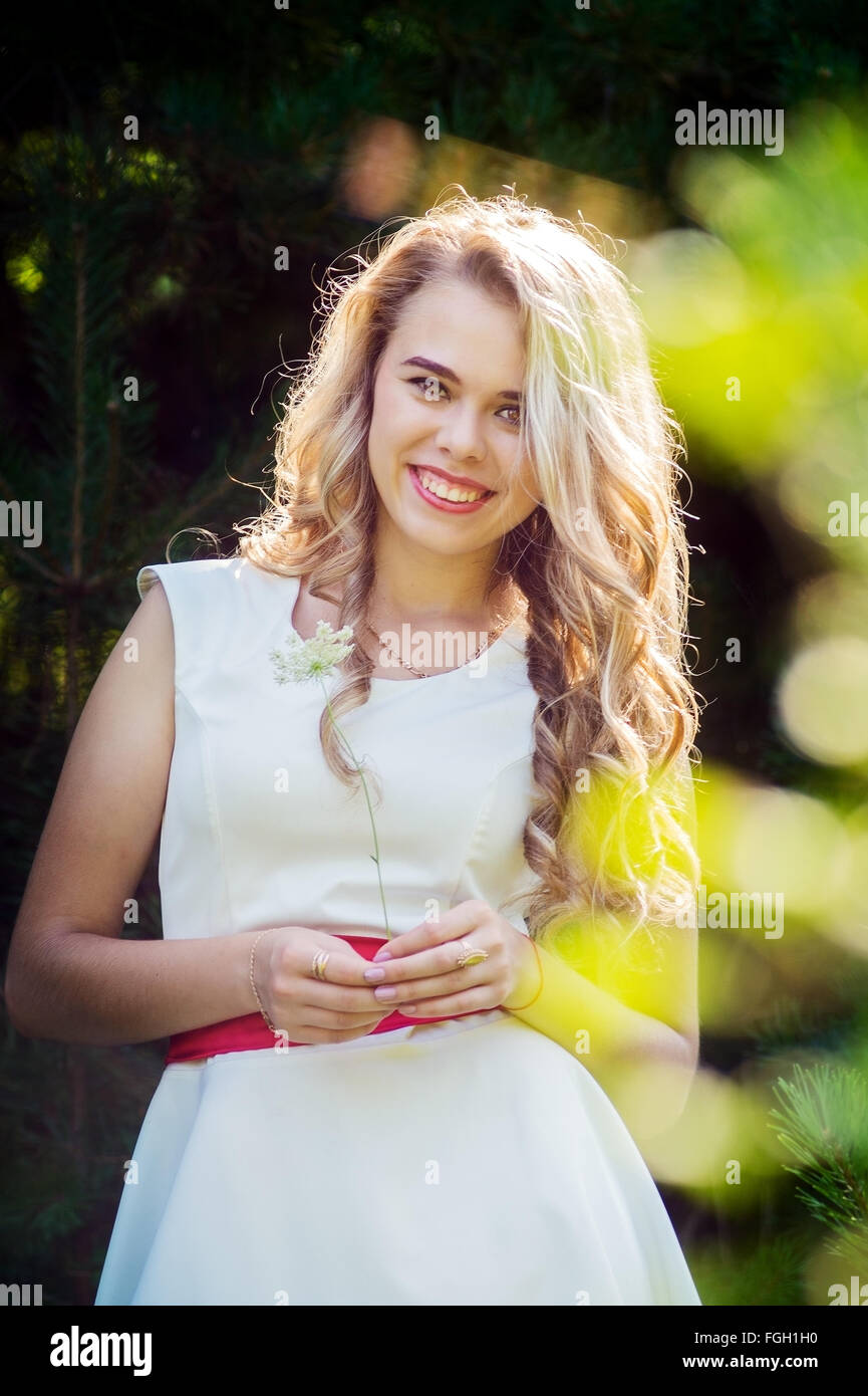 Summer photo smiling girl in a white dress Stock Photo - Alamy