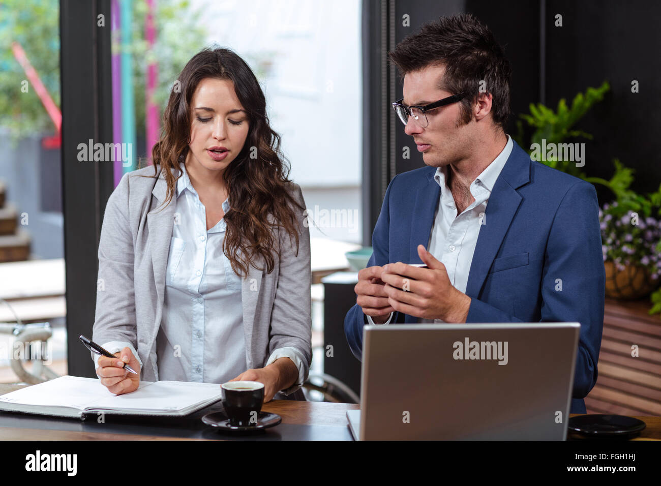 People writing in a notebook Stock Photo - Alamy