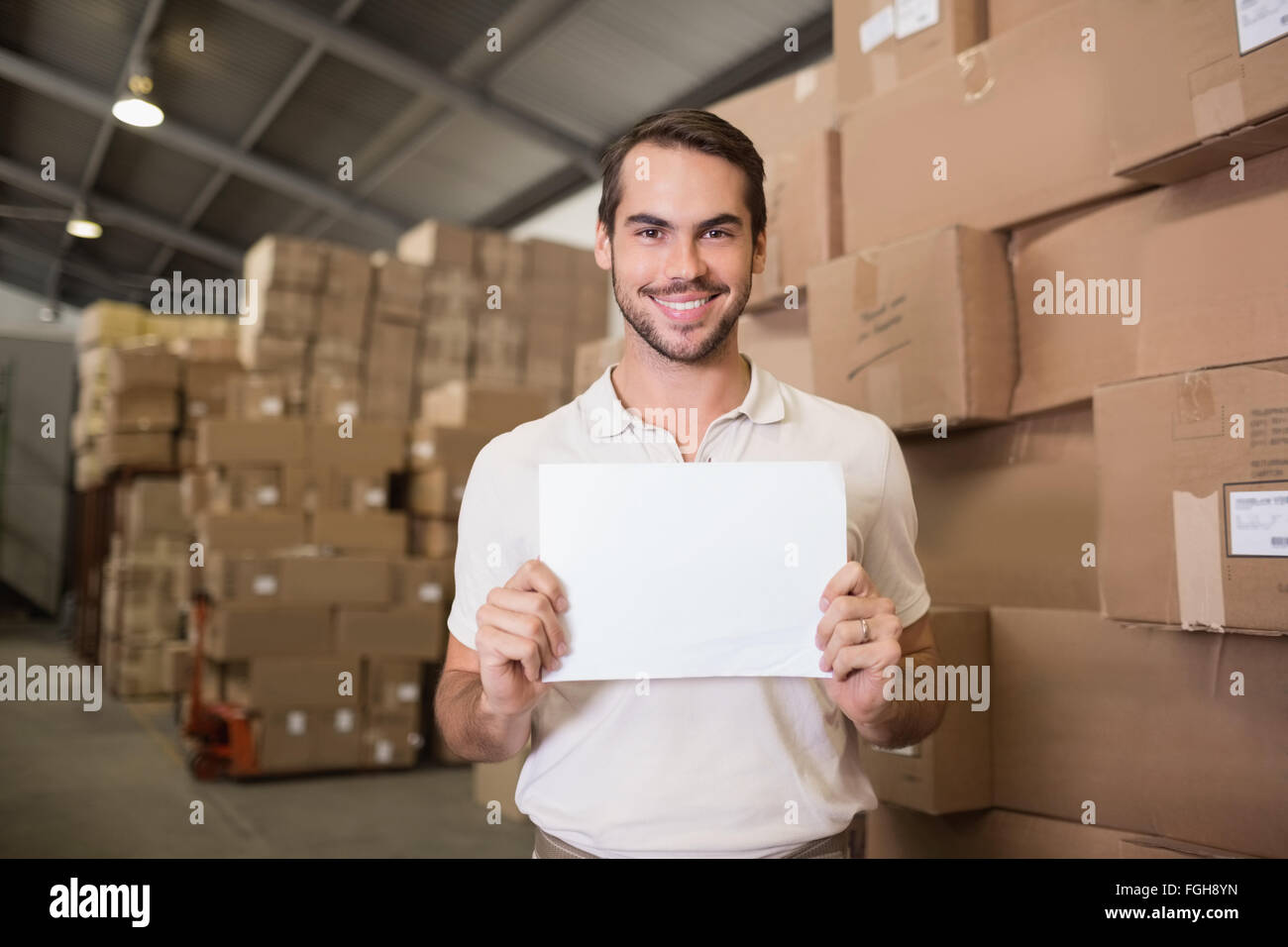 Warehouse worker holding blank board Stock Photo