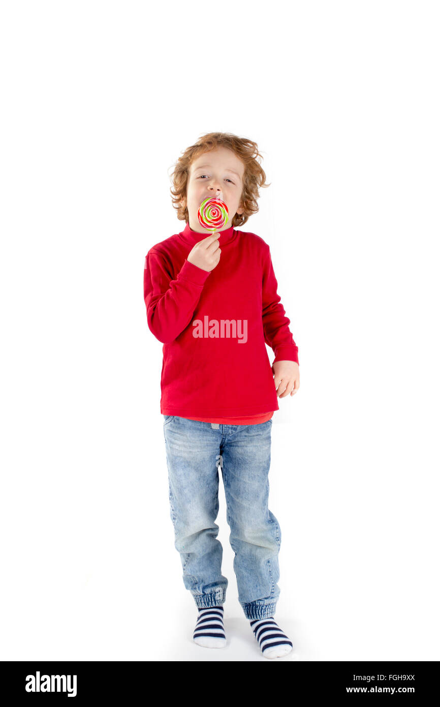 Boy licking lollipop isolated on white background Stock Photo