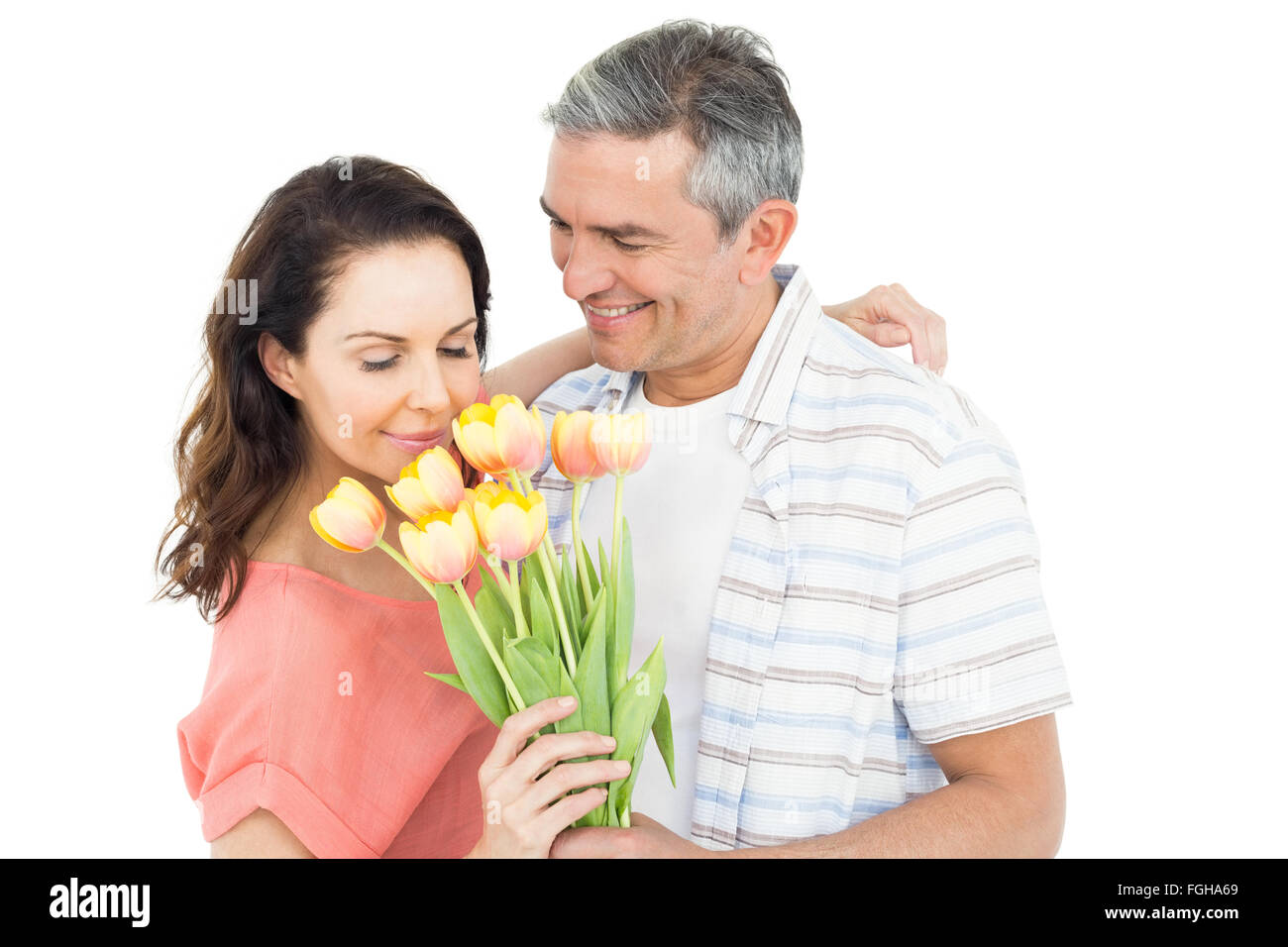 Smiling couple with flowers bouquet Stock Photo