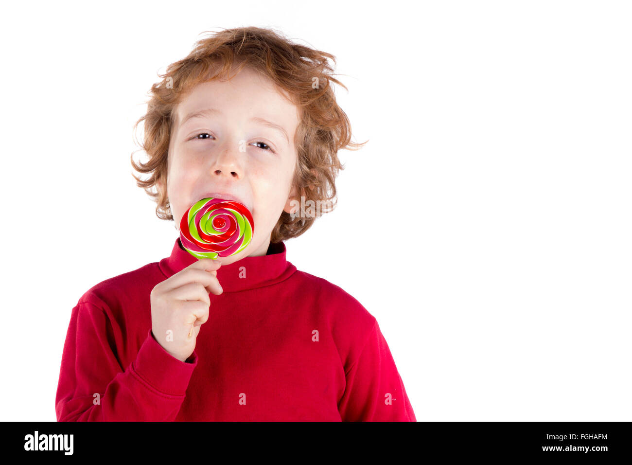 Boy licking lollipop isolated on white background Stock Photo
