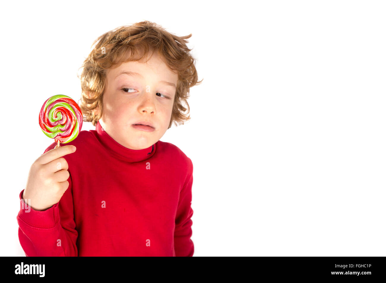 Boy eating lollipop isolated on white background Stock Photo