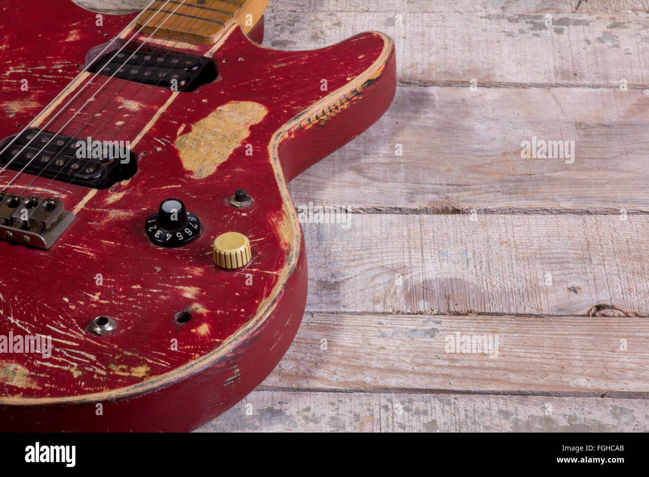 old  electric guitar red retro isolated on wood Stock Photo