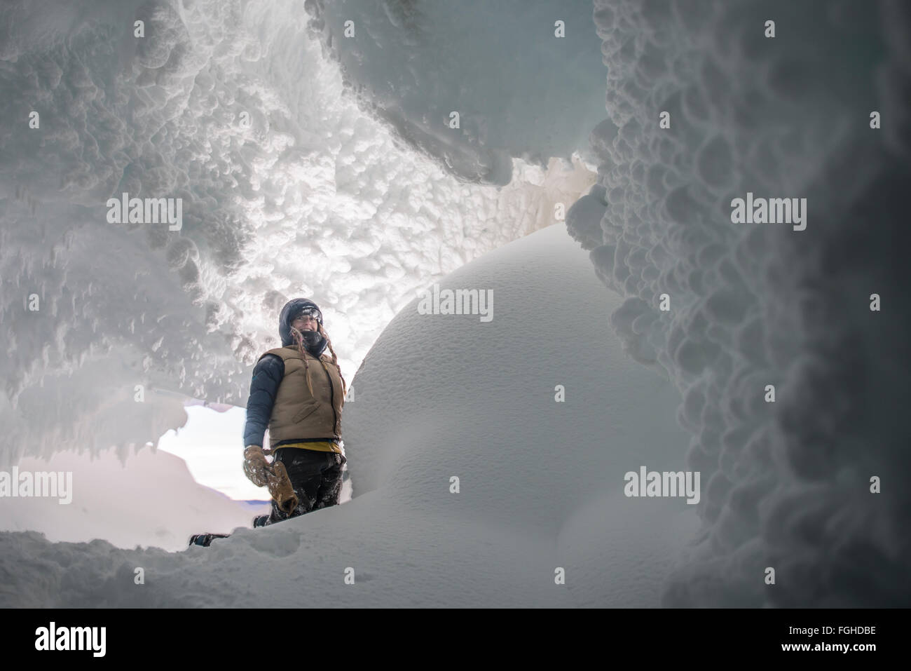 A woman in an ice cave in the Erebus Glacier on Ross Island, Antarctica. Stock Photo