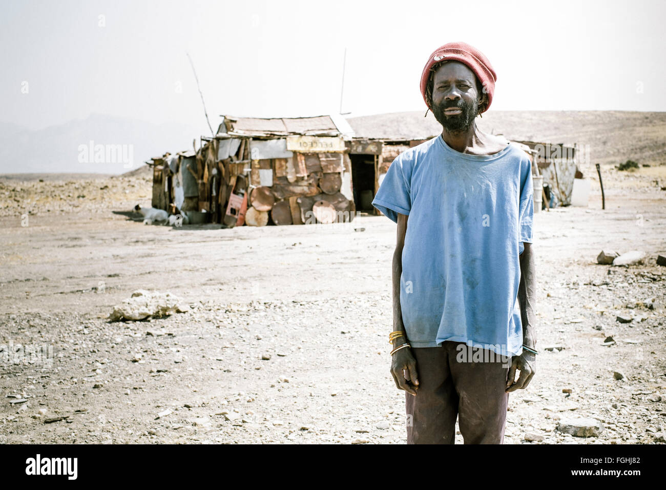 A man stands in front of his house in Namibia Stock Photo