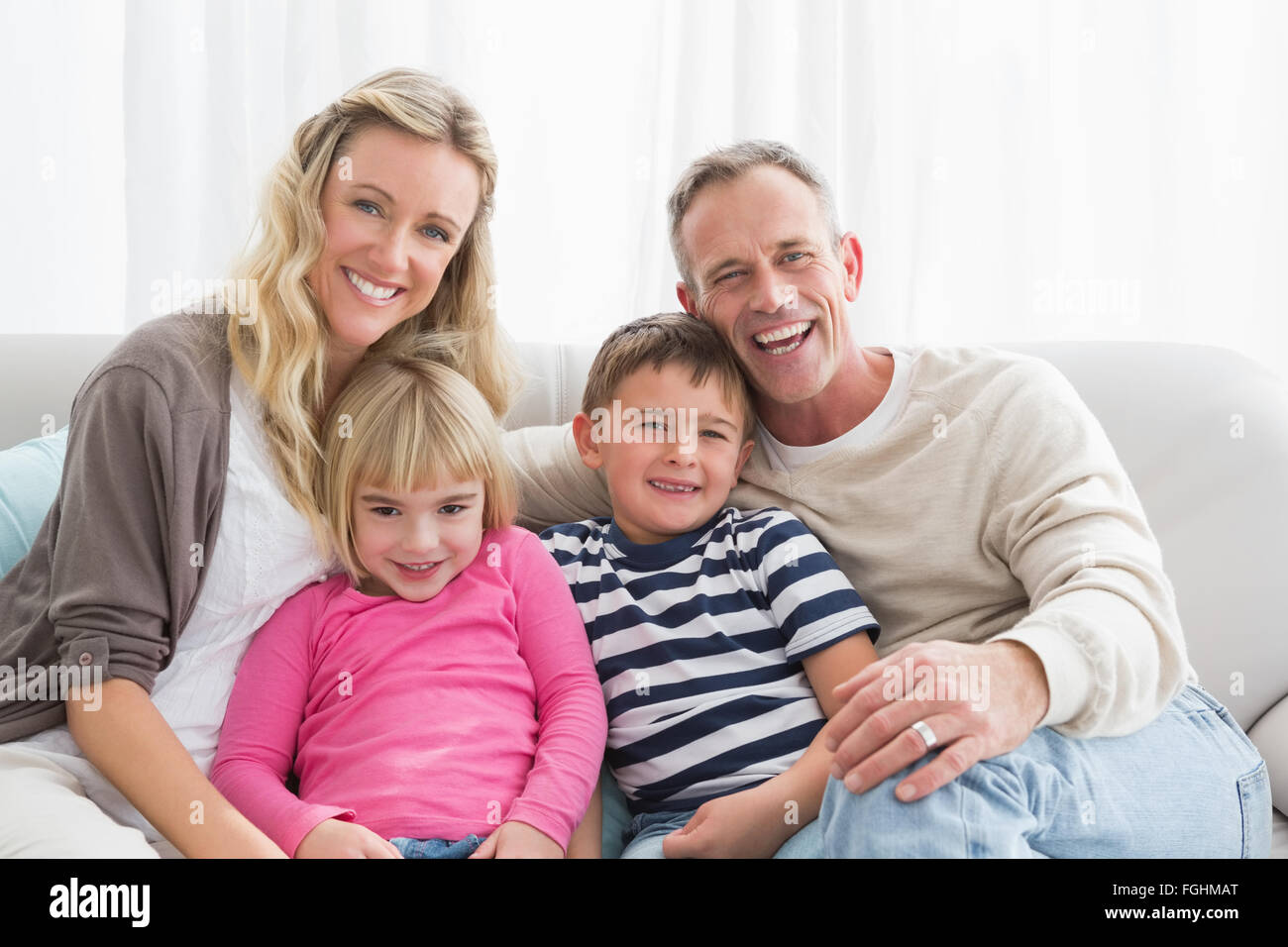Portrait of a cheerful family on the couche Stock Photo Alamy