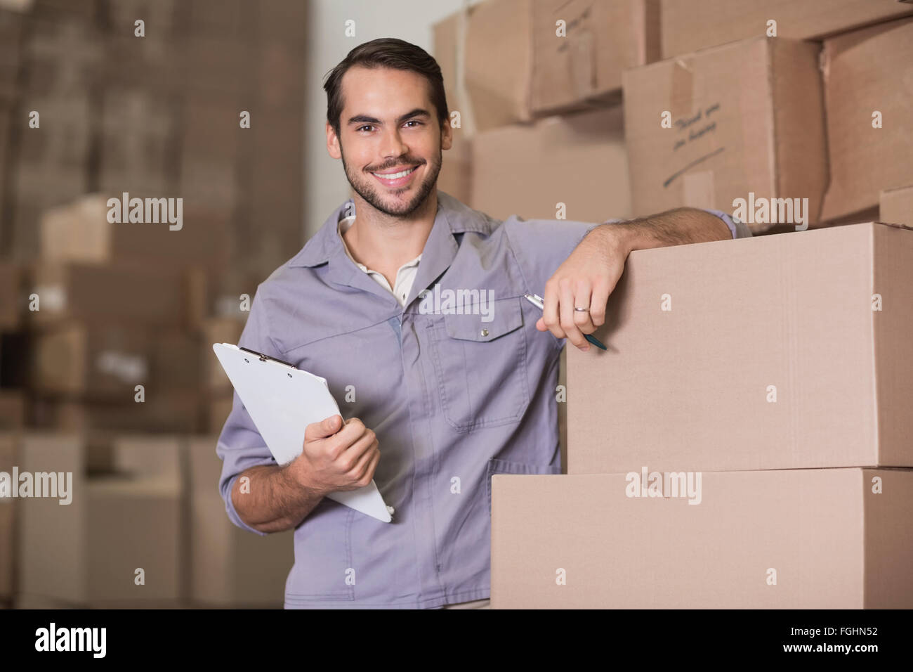 Portrait of worker with clipboard in warehouse Stock Photo