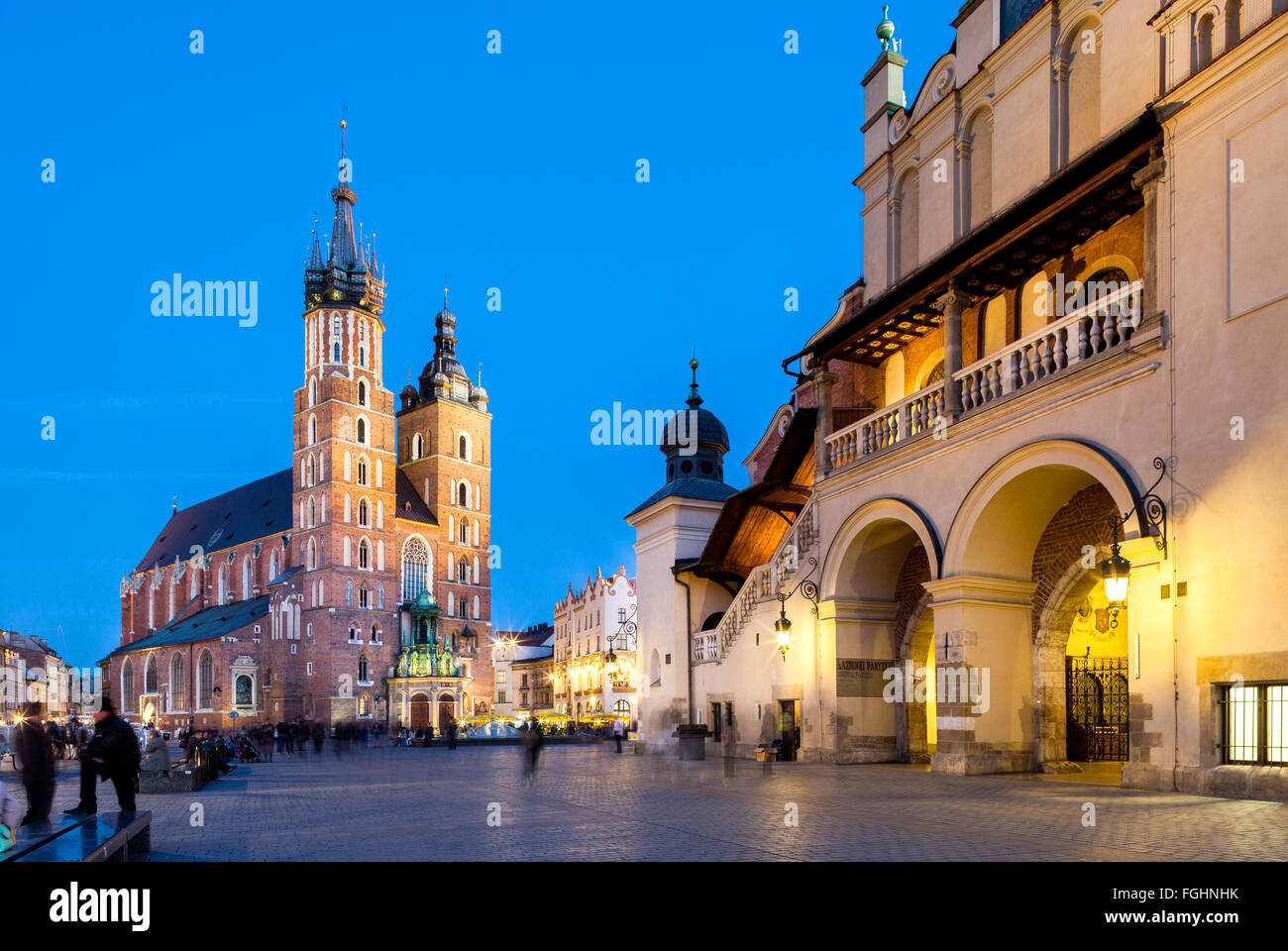 Krakow - Poland - April 22. Krakow - evening picture of old square in Krakow. People walking through the square. Highlighted Kra Stock Photo