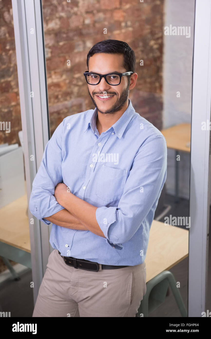 Smiling businessman with arms crossed at office Stock Photo - Alamy