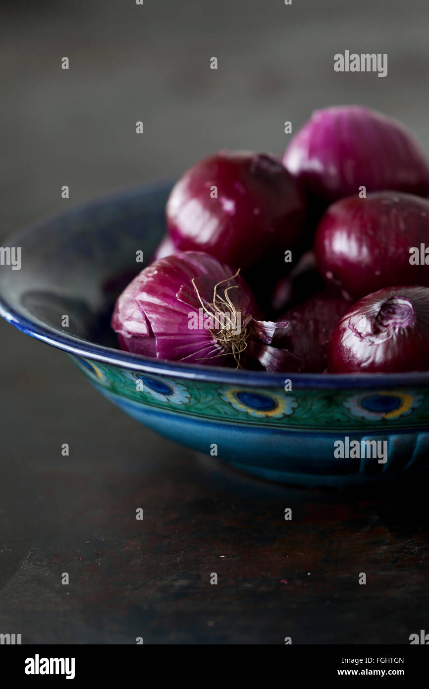 Peeled red onions in a bowl Stock Photo
