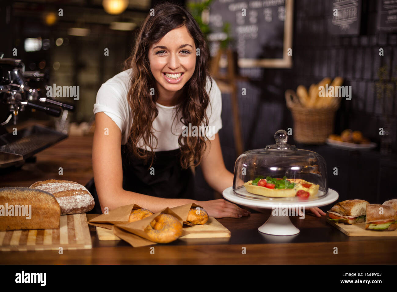 Pretty waitress behind the counter Stock Photo