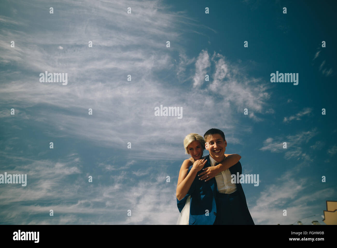 bride and groom on the background of sky Stock Photo - Alamy