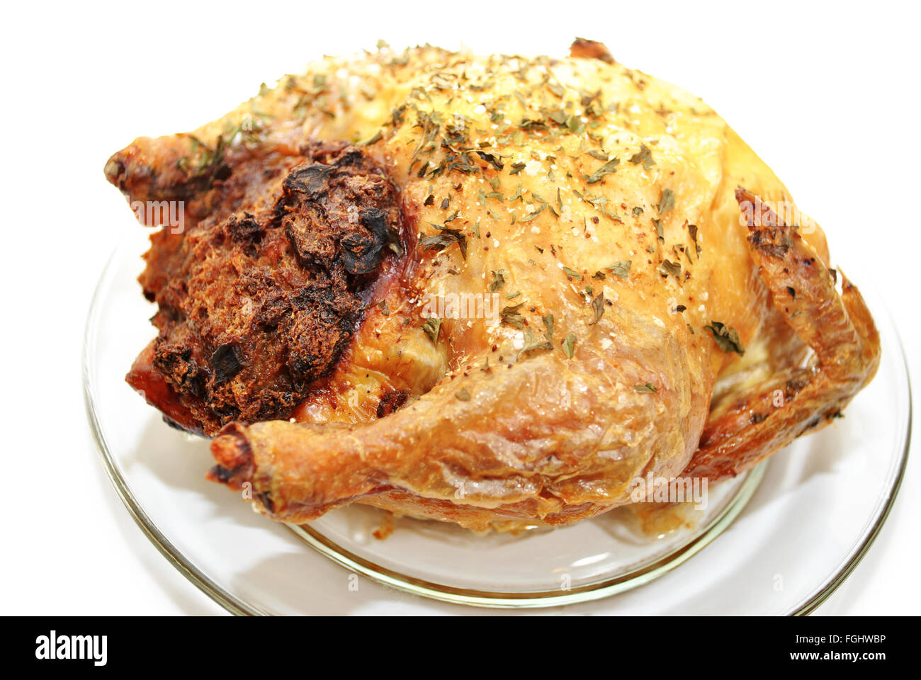 Whole Roasted Chicken with Bread Dressing on a Glass Plate Stock Photo