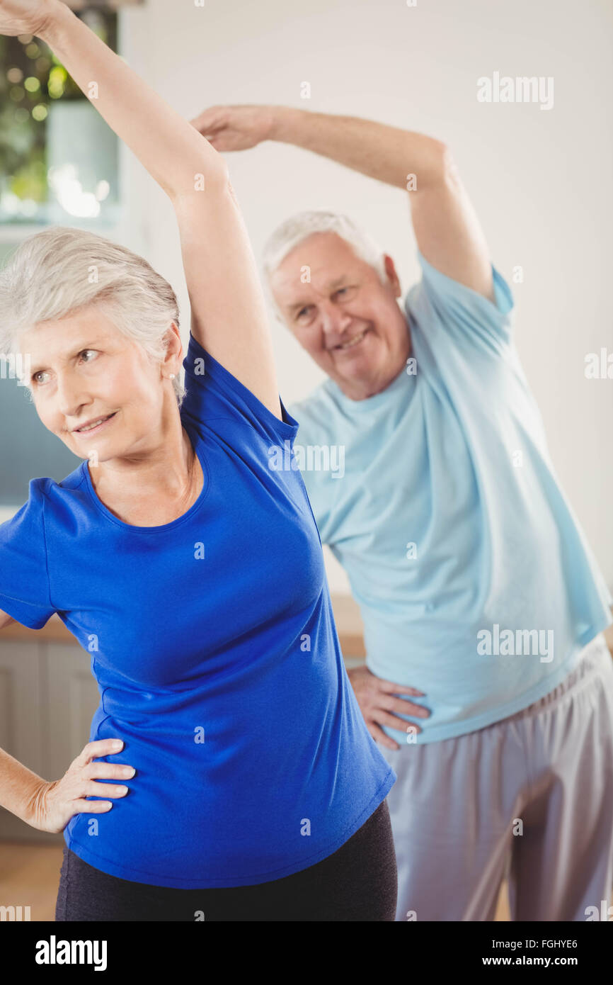Senior couple performing stretching exercise Stock Photo - Alamy