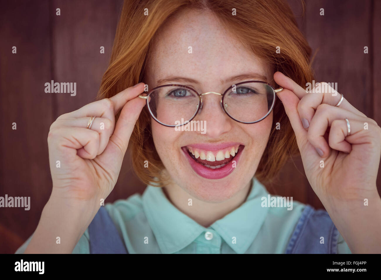 Red-haired hipster woman holding her glasses Stock Photo