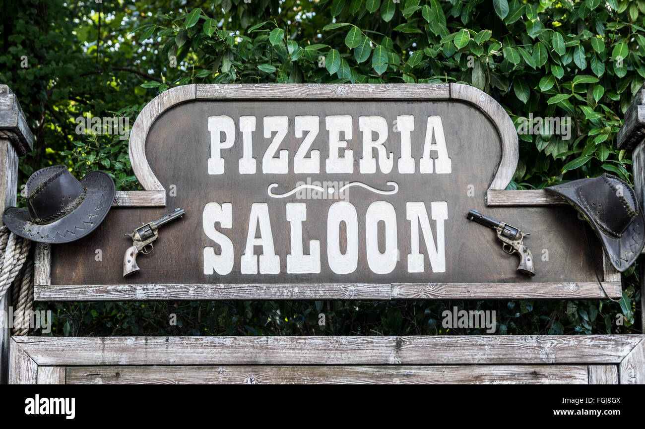 Pizzeria and saloons with revolver and cowboy hats. Stock Photo