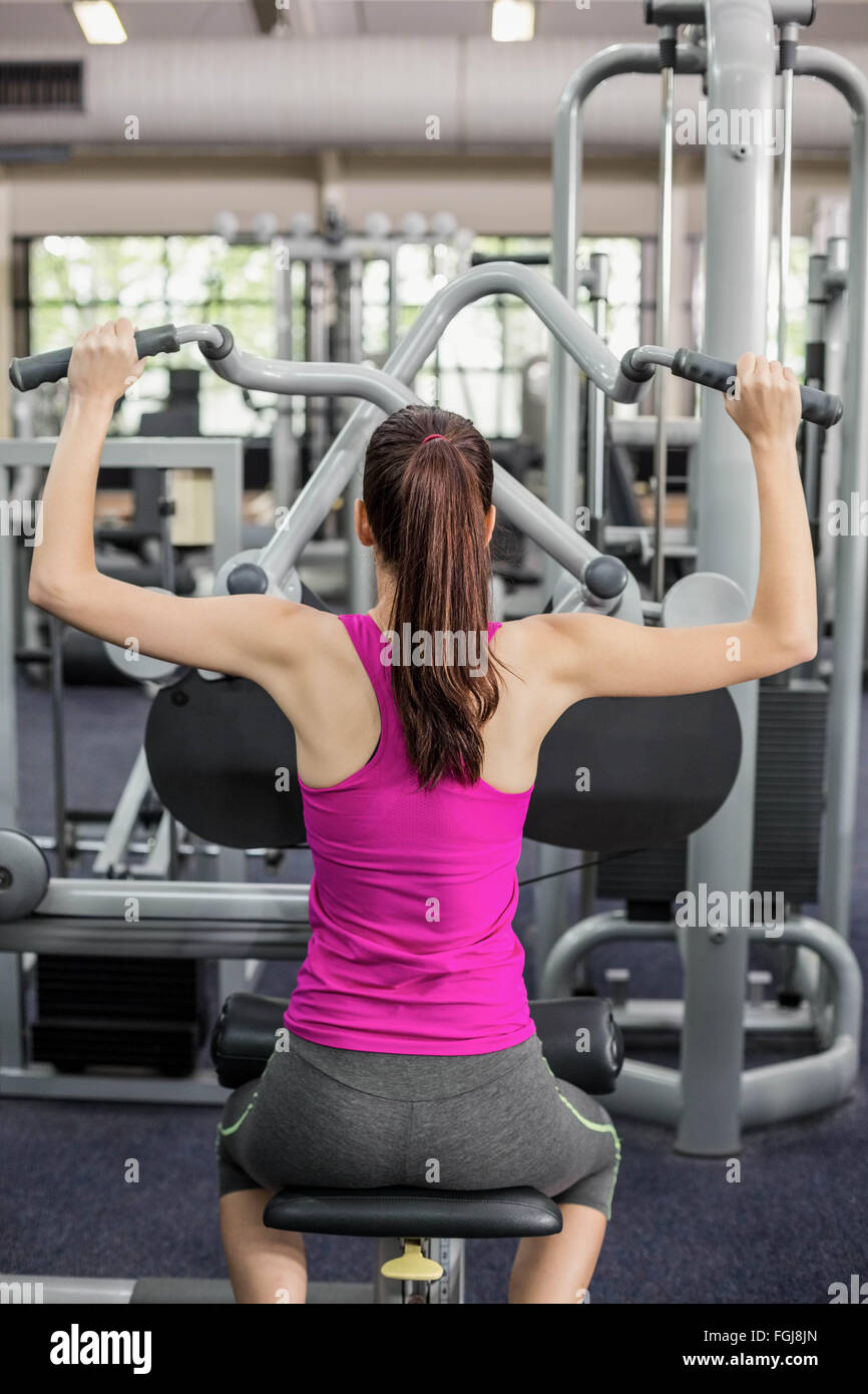 Fit woman using weight machine Stock Photo Alamy