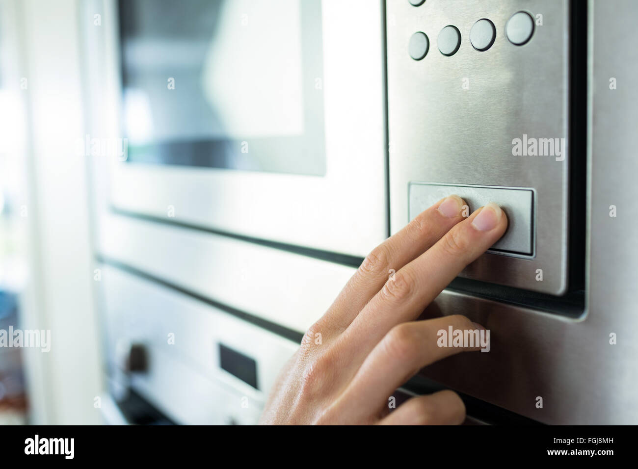 Woman setting up the oven Stock Photo