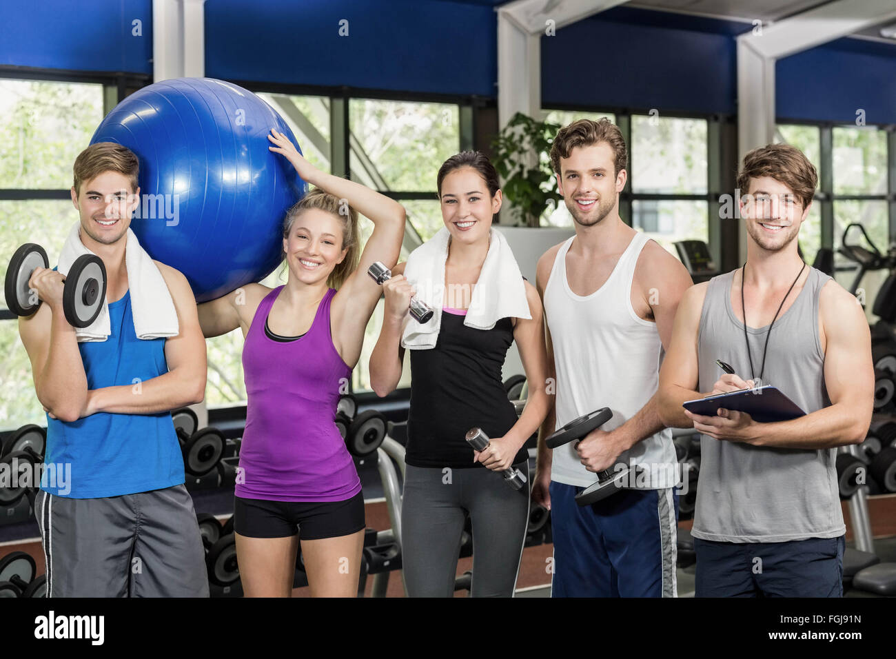 Fit people with sports equipment Stock Photo
