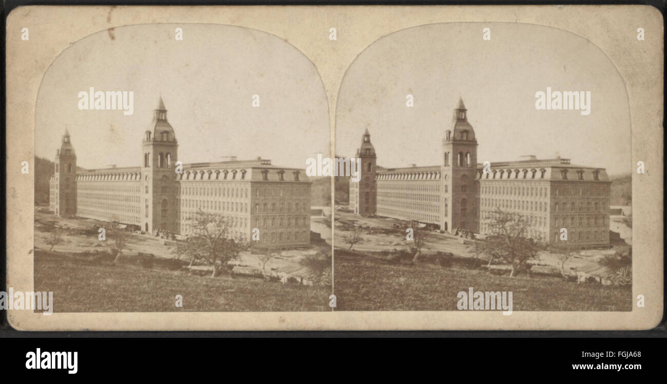 A large mill building with two towers, captured by E. Spafard. The ...