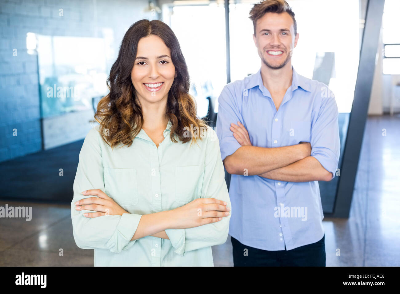 Portrait of colleagues standing in office Stock Photo - Alamy