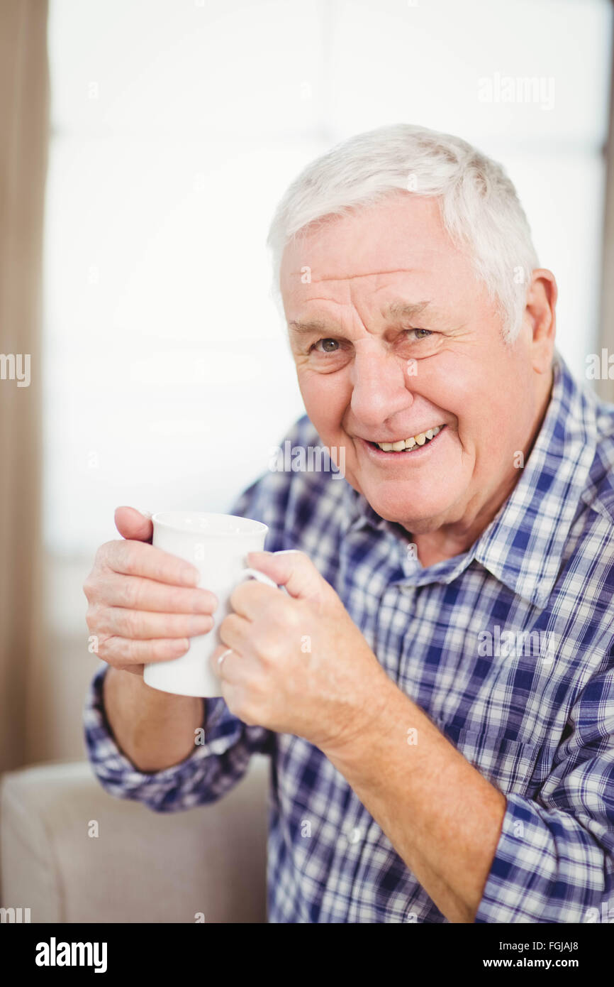 Elderly man holding a coffee cup hires stock photography and images