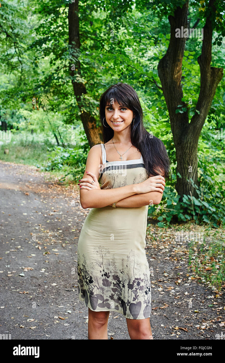 Portrait of a young beautiful woman smiling in the park Stock Photo - Alamy