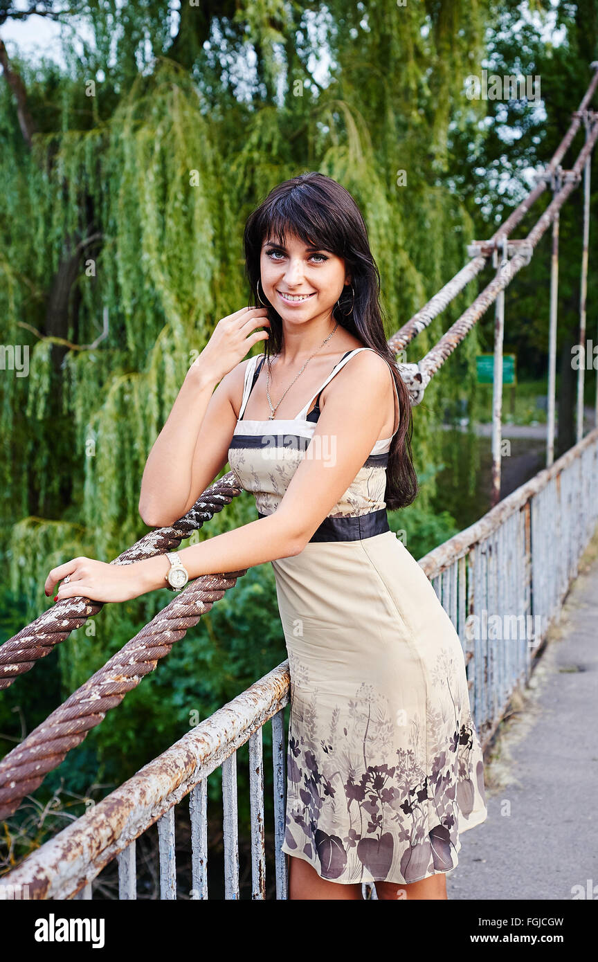 Portrait of a beautiful woman smiling in the park on the bridge Stock ...