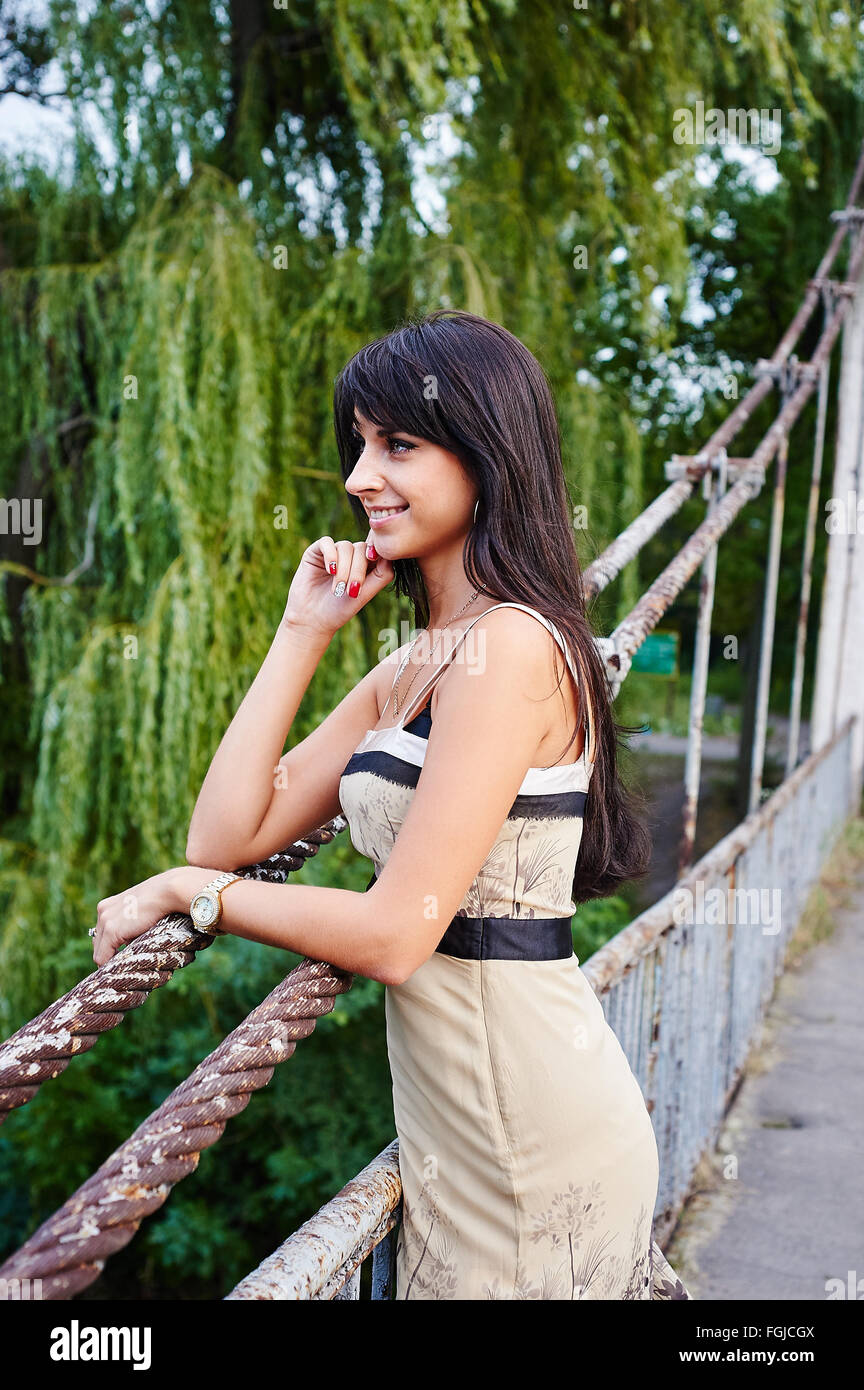 Portrait of a beautiful woman smiling in the park on the bridge Stock ...