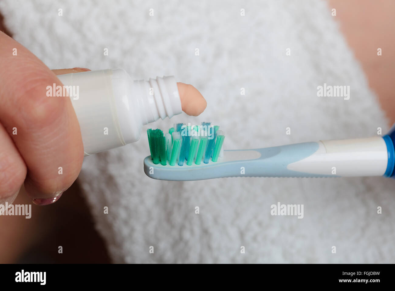 Dental health care. Closeup woman hands holding toothbrush and placing ...