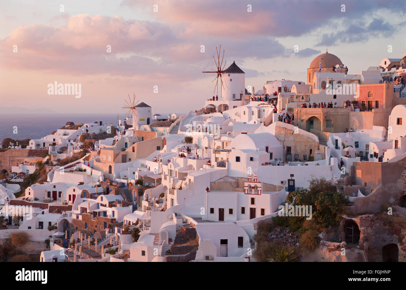 SANTORINI, GREECE - OCTOBER 4, 2015: The look to part of Oia with the windmills in evening light. Stock Photo