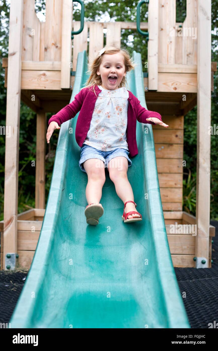 Girl sliding down the slide hi-res stock photography and images