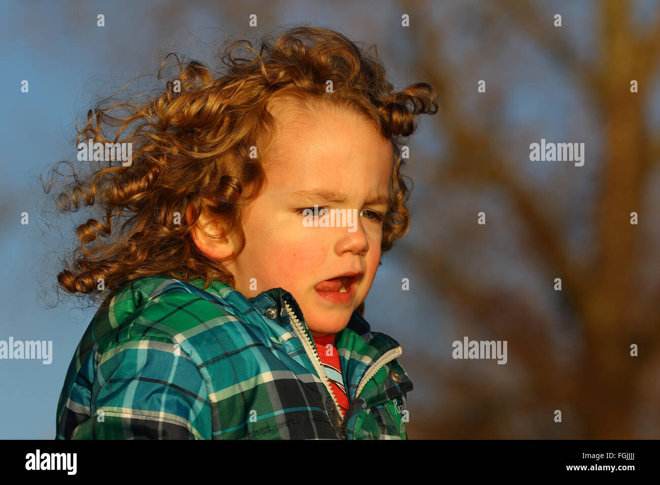 Close shot of curly hair boy running Stock Photo