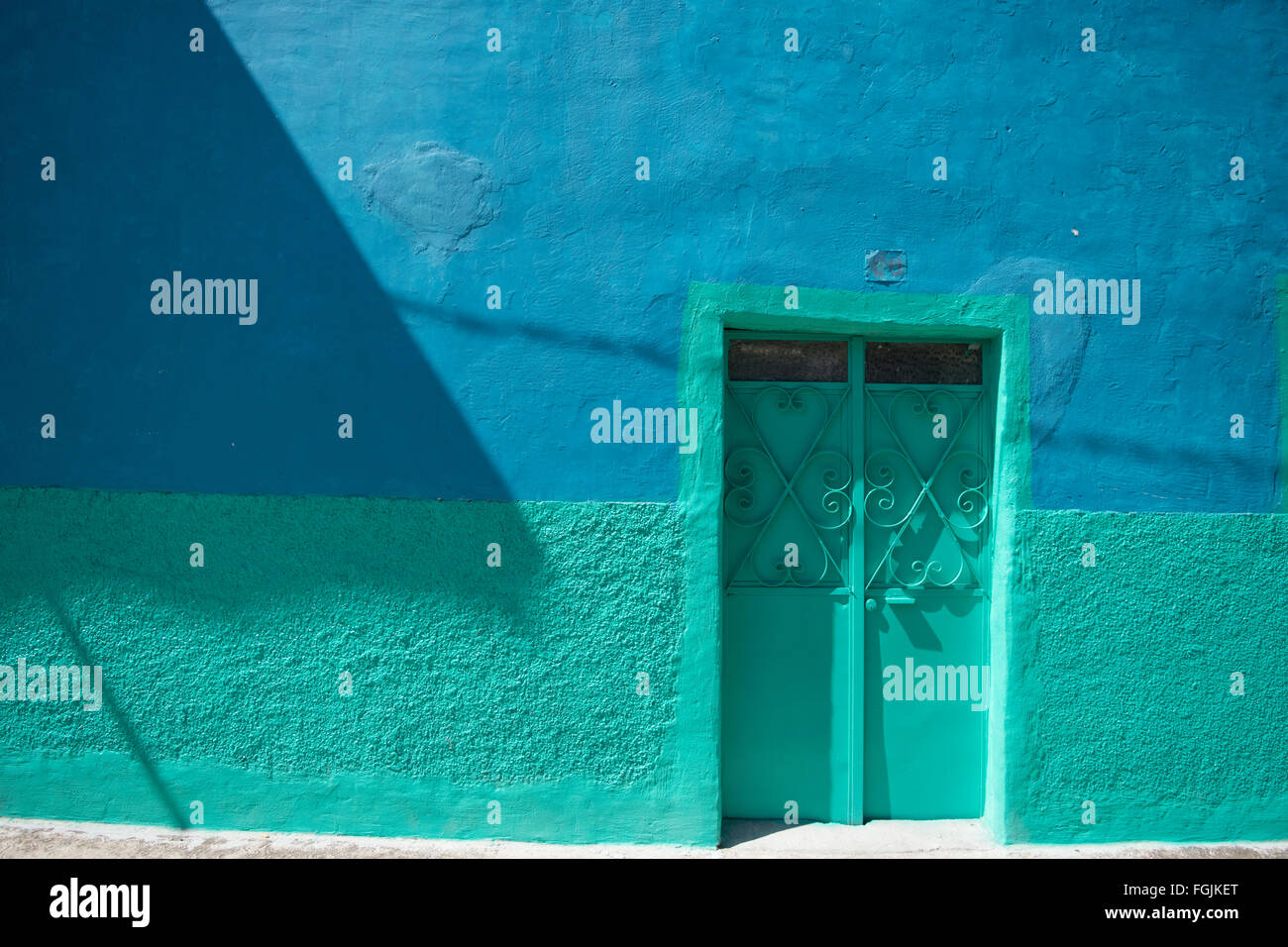 Blue teal front of a home in mexico. Stock Photo