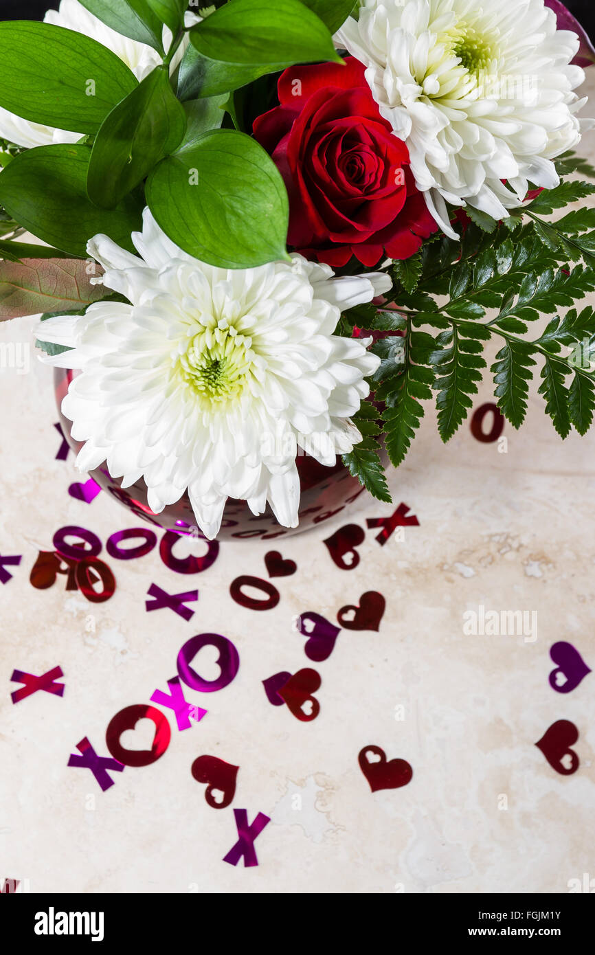 romantic display on a kitchen counter with the letters xoxo spilled over the counter Stock Photo